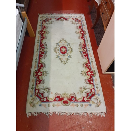 513 - Red & White Floral Patterned Woven Rug with Fringe Ends - 190cm x 94cm.