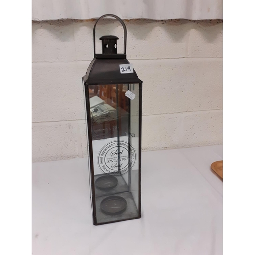 219 - Metal & Glass Hanging Storm Candle Lantern.