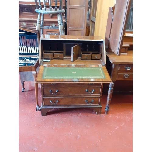 578 - Polished Walnut Writing Bureau over Four Drawers.