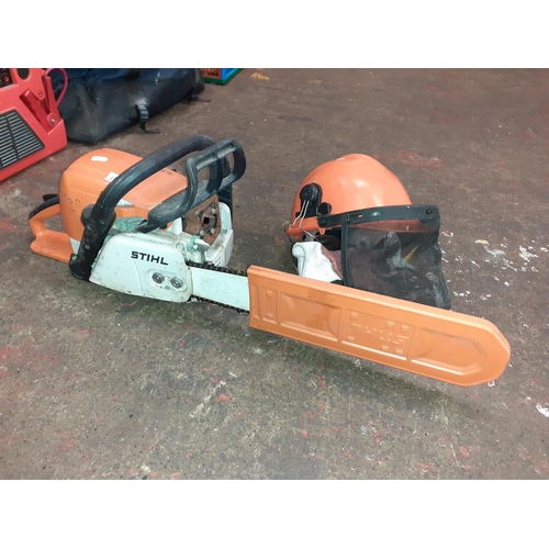 110 - Stihl Petrol Chainsaw with Safety Helmet & Ear Protectors - working.