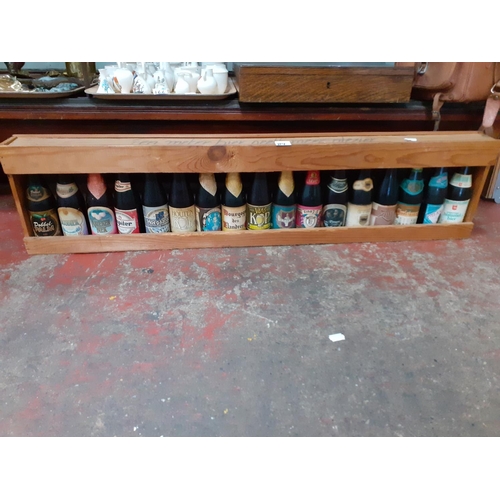 114 - Approx 17 Collectable Beers in Meter Long Wooden Rack.