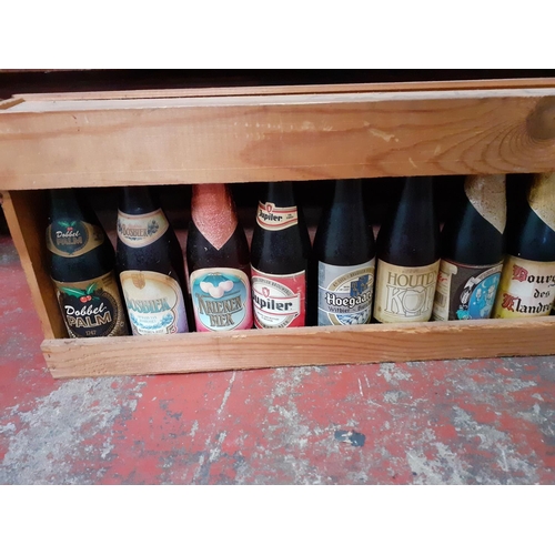 114 - Approx 17 Collectable Beers in Meter Long Wooden Rack.