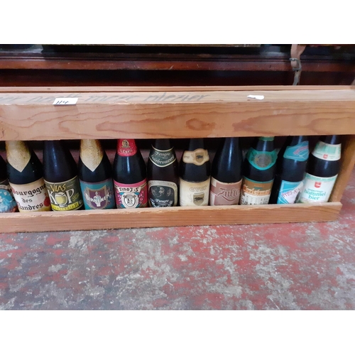 114 - Approx 17 Collectable Beers in Meter Long Wooden Rack.