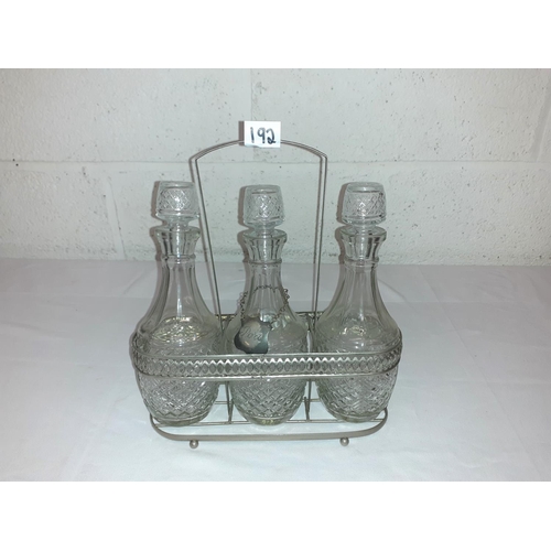 192 - Trio of Cut Glass Decanters in Plated Carry Stand.