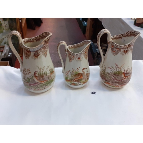 300 - Three Vintage Brown Swansea Bird Scene Graduated Jugs.