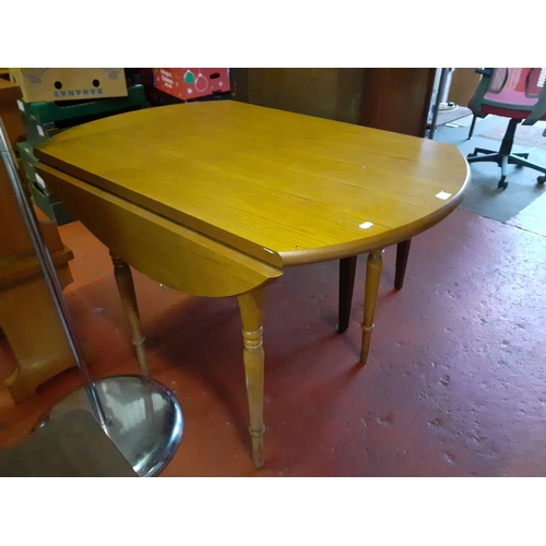 597 - Oak Effect Drop Leaf Table - approx 106cm in diameter.