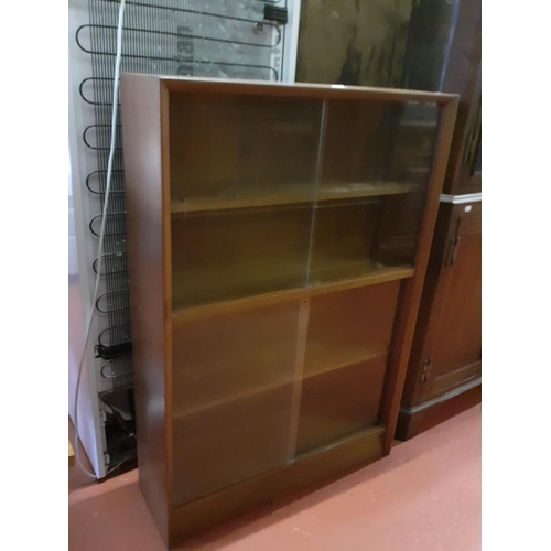 627 - Four Shelf Enclosed Book Case with Two Tier Glazed Sliding Doors.