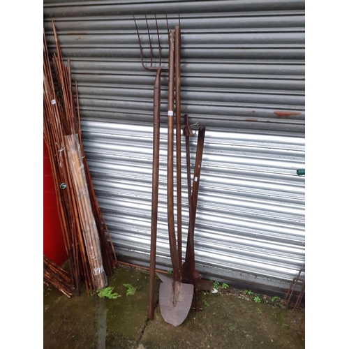 643 - Long Handled Rake, Fork & Shovel along with a Large Clamp.