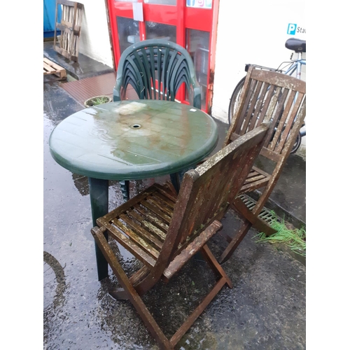 652 - Green Plastic Circular Patio Garden Table with Four Matching Chairs & Two Wooden Folding Chairs.