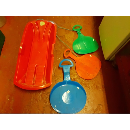 138 - Plastic Red Sledge & Three Sledging Trays.