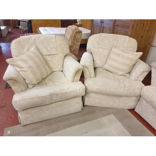 534 - Cream Upholstered Three Seater Settee with Two Matching Arm Chairs & Cushions.