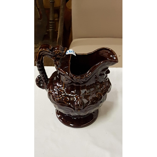 298 - Vintage Brown Treacle Jug with Mask Head Spout.