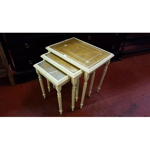 539 - Nest of Three Cream Tables with Tan Leather Inlay Top.