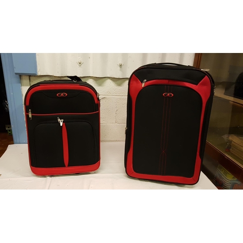 87 - Two Red & Black Graduated Suitcases on Wheels.