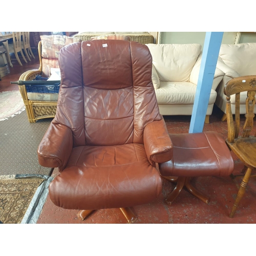 532 - Rust Coloured Leather Effect Swivel & Reclining Chair with Matching Foot Stool.