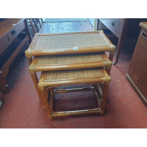 591 - Nest of Three Cane Tables - largest approx 47cm tall x 60cm x 36cm.