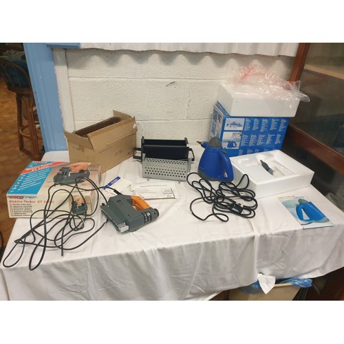 143 - Boxed Universal Steam Cleaner, ESCO Electric Tacker Gun & Boxed Briquette Maker with Instructions.