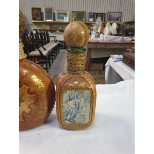 220 - Two Italian Leather Clad Bottles with Stoppers.
