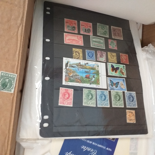 41 - Glory box with 100's of packets of stamps on album pages, wide selection viewing required.