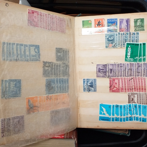 24 - Black plastic carton housing a small collection of albums and bags of stamps/covers etc, mostly SE A... 