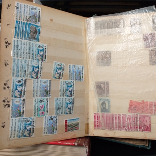 24 - Black plastic carton housing a small collection of albums and bags of stamps/covers etc, mostly SE A... 