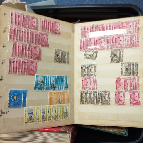 24 - Black plastic carton housing a small collection of albums and bags of stamps/covers etc, mostly SE A... 