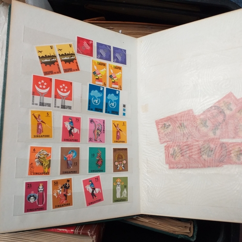24 - Black plastic carton housing a small collection of albums and bags of stamps/covers etc, mostly SE A... 