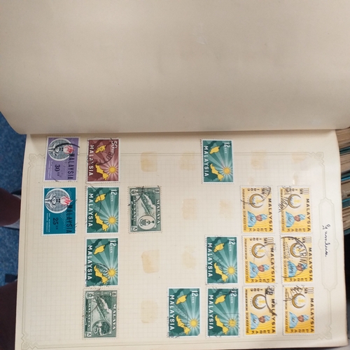24 - Black plastic carton housing a small collection of albums and bags of stamps/covers etc, mostly SE A... 