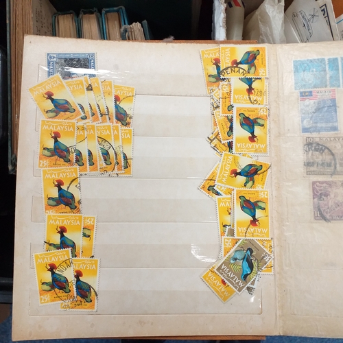 24 - Black plastic carton housing a small collection of albums and bags of stamps/covers etc, mostly SE A... 