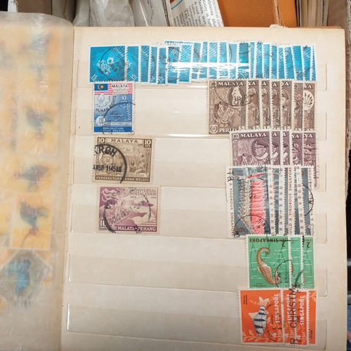 24 - Black plastic carton housing a small collection of albums and bags of stamps/covers etc, mostly SE A... 