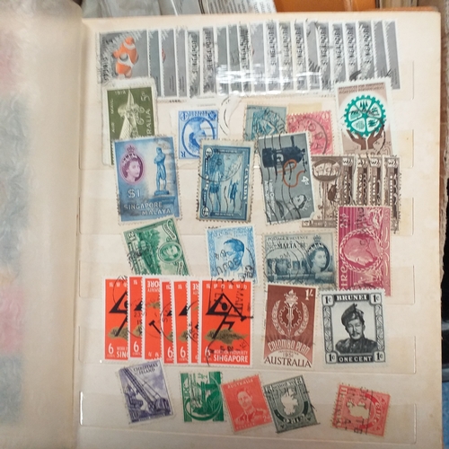 24 - Black plastic carton housing a small collection of albums and bags of stamps/covers etc, mostly SE A... 