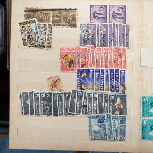 24 - Black plastic carton housing a small collection of albums and bags of stamps/covers etc, mostly SE A... 