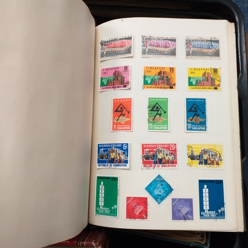 24 - Black plastic carton housing a small collection of albums and bags of stamps/covers etc, mostly SE A... 