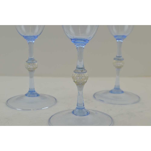 111 - A SET OF SIX MURANO WINE GLASSES, pale blue tinted with bell bowls, knopped stems on raised circular... 