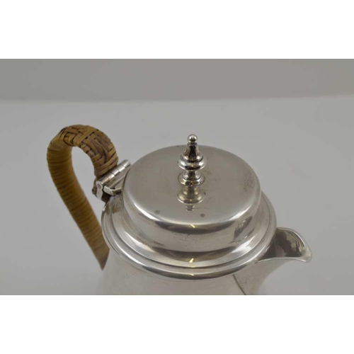 15 - WILLIAM COMYNS & SONS LTD AN EARLY 20TH CENTURY SILVER LIDDED HOT WATER / MILK JUG with cane bound h... 