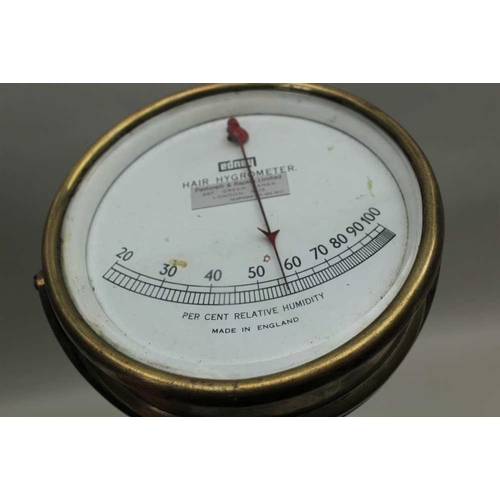 174 - A BRASS HAIR HYGROMETER with calibrated dial, 13cm diameter 