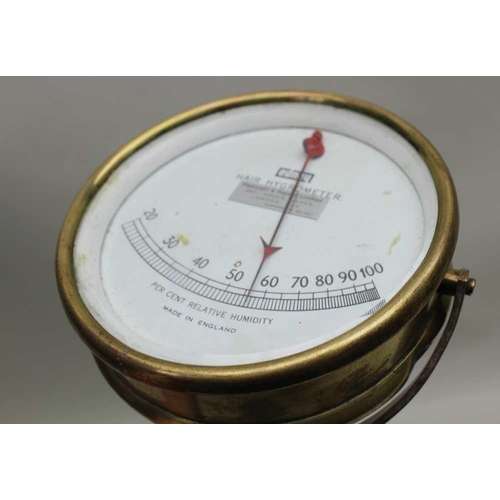 174 - A BRASS HAIR HYGROMETER with calibrated dial, 13cm diameter 