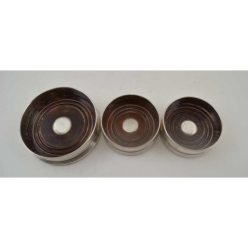 2 - W.I. BROADWAY & CO. THREE SILVER GALLERY BOTTLE COASTERS, turned wood bases, engine turned decoratio... 