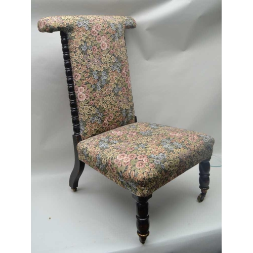 256 - A LATE VICTORIAN PRIE DIEU CHAIR, turned ebonised frame, on castors, with floral decorated upholster... 