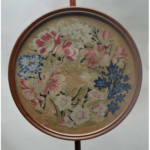 263 - A 19TH CENTURY MAHOGANY POLE SCREEN, raised on triform base, fitted a circular framed panel, with fl... 