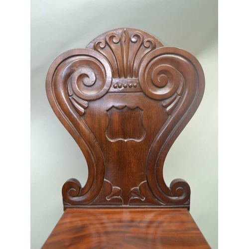 304 - A PAIR OF WILLIAM IV PERIOD MAHOGANY HALL CHAIRS with fancy shaped and carved backs, and solid seats... 