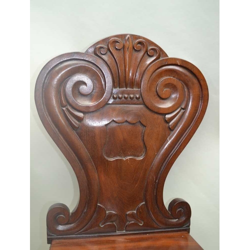 304 - A PAIR OF WILLIAM IV PERIOD MAHOGANY HALL CHAIRS with fancy shaped and carved backs, and solid seats... 