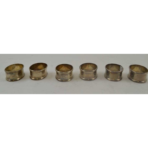 42 - A SET OF SIX SILVER NAPKIN RINGS of plain oval form, combined weight; 114g 