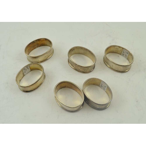 42 - A SET OF SIX SILVER NAPKIN RINGS of plain oval form, combined weight; 114g 