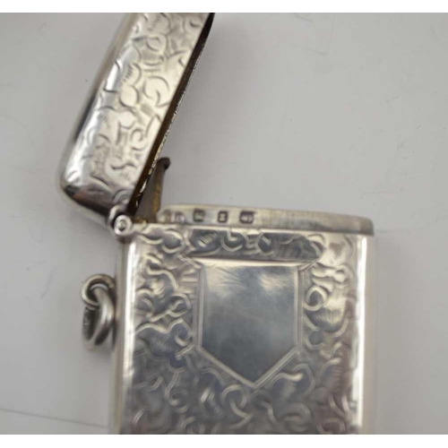 6 - A LATE VICTORIAN SILVER VESTA CASE, chased decoration with blind cartouche, Birmingham 1899, possibl... 