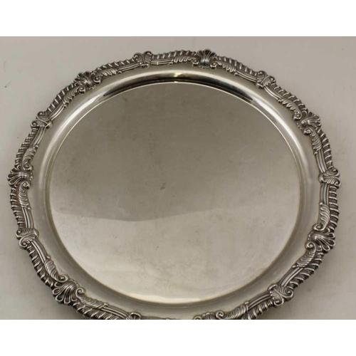 62 - FRANK COBB & CO. LTD A GEORGIAN DESIGN SILVER SALVER with decorative rim, raised on three ball & cla... 