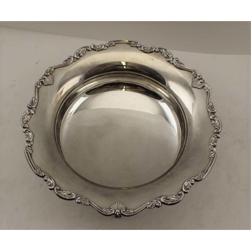 66 - COOPER BROTHERS & SONS LTD A SILVER FRUIT BOWL with acanthus leaf rim, raised on three decorative su... 