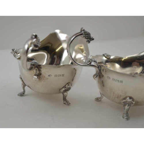 8 - ADIE BROTHERS. LTD A PAIR OF SILVER SAUCE BOATS OF GEORGIAN DESIGN, with cast Celtic form mask handl... 