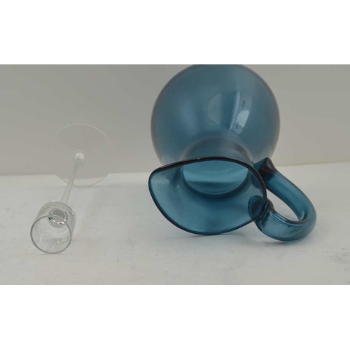 97 - A 'KING'S LYNN' BLUE TINTED GLASS JUG AND FINE STEMMED CLEAR GLASS CANDLE STAND, 20cm high (2) 