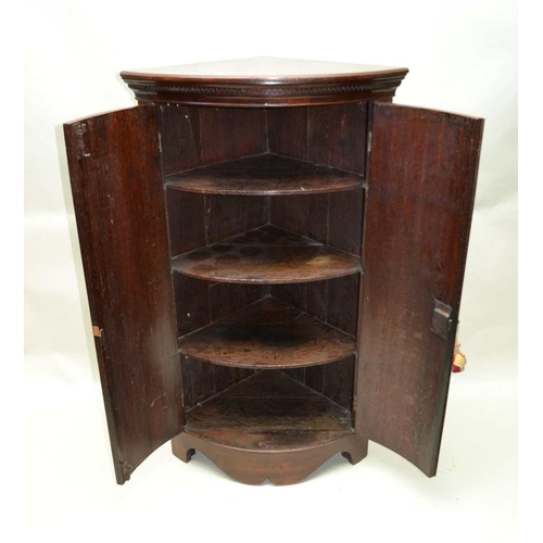 276 - A GEORGIAN DESIGN MAHOGANY FLOOR STANDING BOW FRONT CORNER CUPBOARD, fitted two doors raised on brac... 